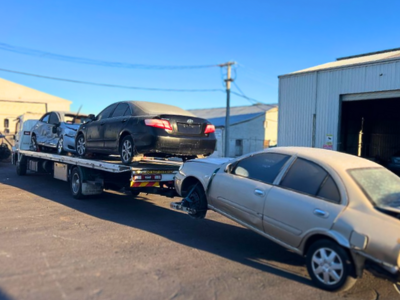 junk cars being towed