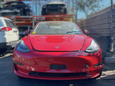 red tesla being wrecked